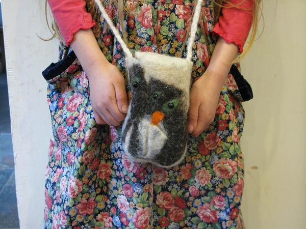 Four penguins huddled in a storm