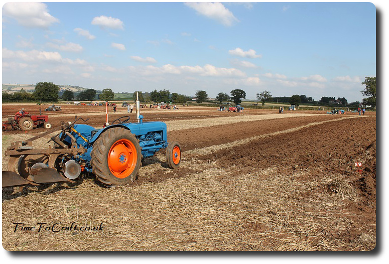 orange and blue tractor at ploughing match
