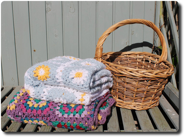 crochet daisy granny square blanket blue beside basket