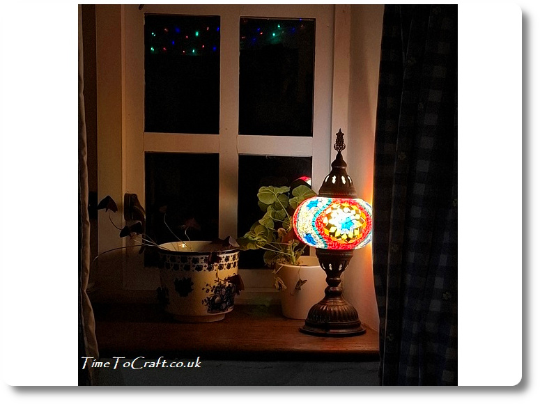 lamp lit on windowsill